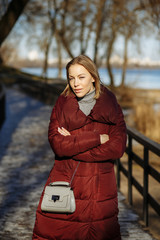 girl posing on a bridge over a river