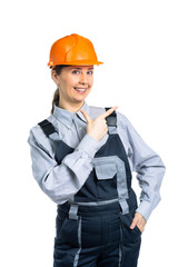 girl construction engineer smiling and showing a gesture of the finger to the side. Isolated