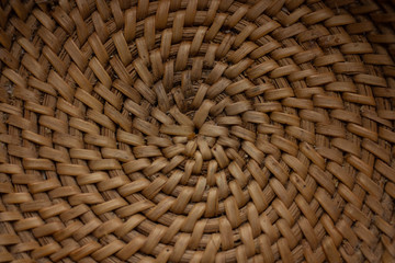 The bottom of a small wicker basket close-up