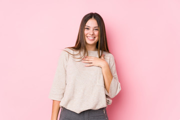 Young caucasian woman posing isolated laughs out loudly keeping hand on chest.