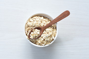 Natural oatmeal on light wooden background