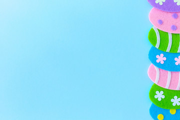 Cute blue Easter holiday photo background with colorful handmade eggs.