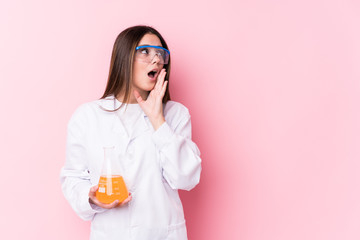 Young chemical woman isolated is saying a secret hot braking news and looking aside