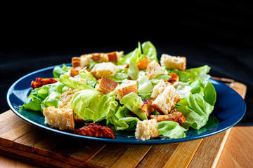 Caesar salad with chicken meat, lettuce and croutons