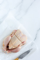 Whole uncooked chicken with herbs and spices