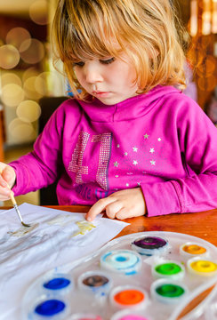 portrait of a pretty little girl painting
