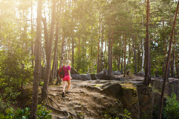 stylish hipster woman with backpack looking at amazing woods and mountains in summer, travel...