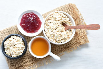 Natural oatmeal on light wooden background