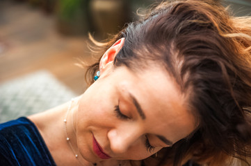 Woman and earrings made of natural stones. The mysticism of amulets. Esoterics in handmade jewelry close-up and copy space. Jewelry on the female neck.