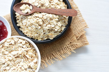 Natural oatmeal on light wooden background