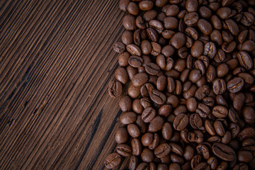 Roasted Coffee beanscon brown table. Flat lay