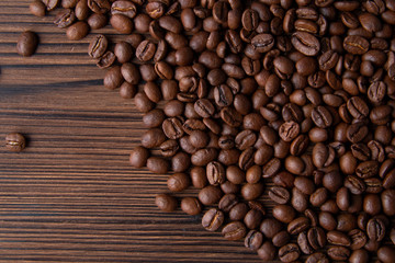Roasted Coffee beanscon brown table. Flat lay