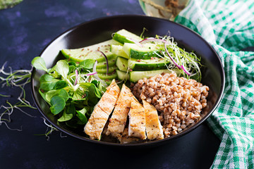 Lunch salad. Buddha bowl with buckwheat porridge, grilled chicken fillet, corn salad, microgreens and daikon. Healthy food.