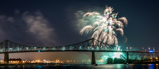 Photograph of fireworks. Jacques Cartier bridge with fireworks. Montreal Quebec. Fireworks.