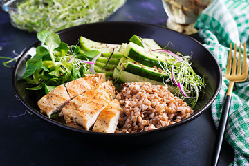Lunch salad. Buddha bowl with buckwheat porridge, grilled chicken fillet, corn salad, microgreens and daikon. Healthy food.