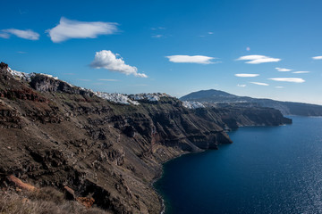 Volcanic cliffs over Aegan sea of caldera on Santorini island with panoramic view of few villages and towns including Fira (Thira)
