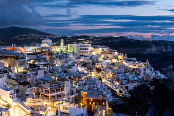 Fototapeta premium Panoramic view of Thira (Thera, Fira) resort town on Santorini island during sunset in summer