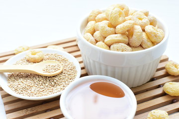 Quinoa cereal, accompanied by seeds and honey