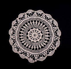 White hand made crocheted coaster lace doily on black background - obrazy, fototapety, plakaty