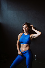 Fototapeta na wymiar Girl shows her pumped belly press. Athletic body after diet and heavy exercise, slim waist