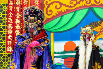 Unidentified Chinese opera actors performs traditional drama and shows mark face-changing on stage in Ayutthaya, Thailand.