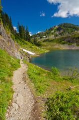 Fototapeta na wymiar Fragment of a trail with beautiful mountain lake in Mount Baker Visitor Center, WA, USA.