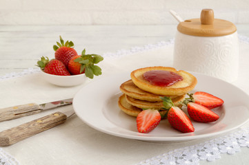 pancakes with jam and strawberries.
