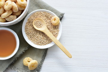 Quinoa cereal, accompanied by seeds and honey