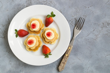 pancakes with jam and strawberries.