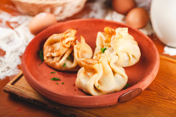 Three bags of thin pancakes (crepes, blini) with filling. Traditional Maslenitsa (Shrovetide or Butter Week) festival meal.