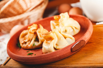 Three bags of thin pancakes (crepes, blini) with filling. Traditional Maslenitsa (Shrovetide or Butter Week) festival meal.