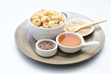 Quinoa cereal, accompanied by seeds and honey