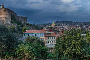 Fototapeta na wymiar evening view of the old city of Tbilisi in Georgia, Narikala fortress and the city center against a stormy sky