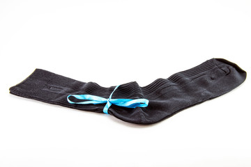 black sock on a white background,black socks tied with a blue ribbon 