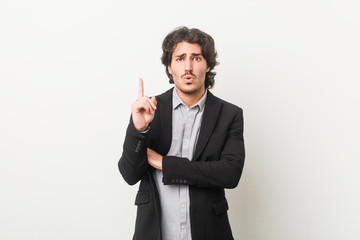 Young business man against a white background having some great idea, concept of creativity.