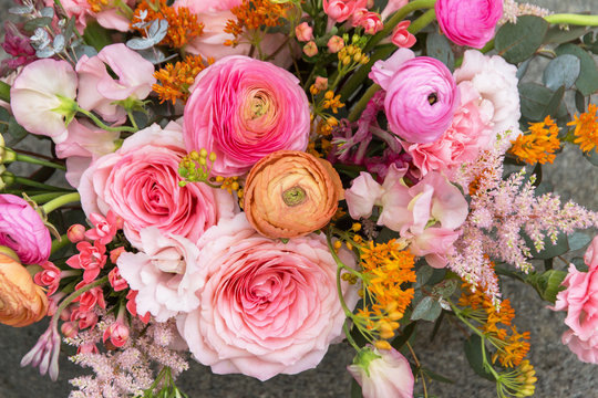 Floral backdrop, background. Flowers in bloom. Orange pink bouquet with roses close-up, details