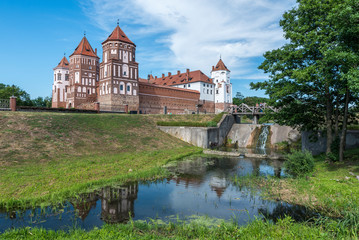 Fototapeta premium Mir Castle Complex in Belarus with waterfall (water mill) on river