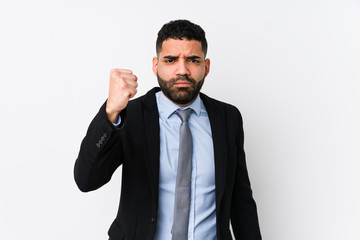 Young latin business woman against a white background isolated showing fist to camera, aggressive facial expression.