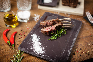 Grilled lamb chops served with a branch of rosemary