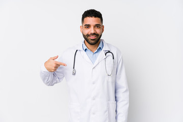 Young arabian doctor man isolated person pointing by hand to a shirt copy space, proud and confident