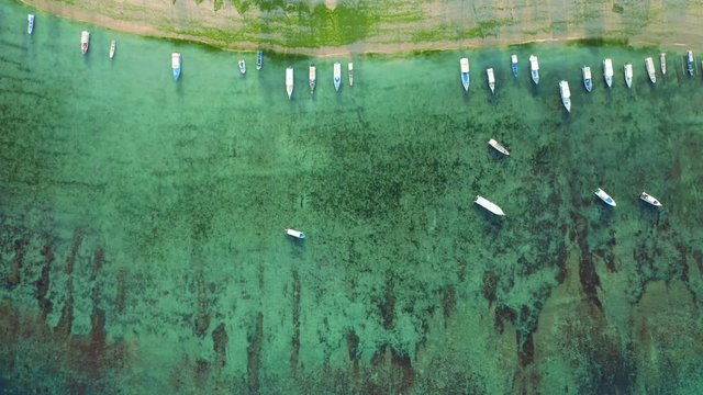 Aerial drone flight over anchored boats at beautiful coast, Bali, Indonesia, 4k
