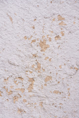 Old white and yellow plaster shell rock wall texture background. Top view