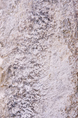 Old shabby plastered white and grey stone wall background. Top view