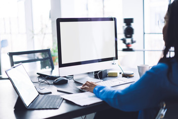 Woman using computer with blank screen