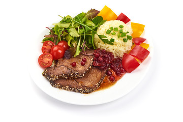 Juicy roast pork slices with rice and vegetables, isolated on white background