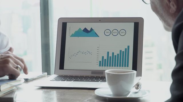 Two senior businessman planning target finance from statistic graph on laptop computer in the office, manager meeting and discussion and analysis from information chart of sales for marketing.