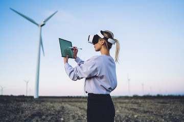 Female in VR headset painting on touch pad for virtual reality