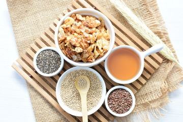 Granola mix accompanied by seeds and honey