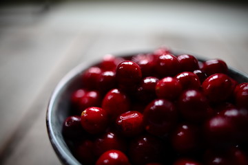 close up of cranberries on wooden background
