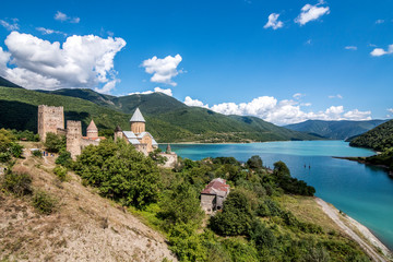 Fototapeta na wymiar Ananuri in Georgia, fortress with orthodox monastery and reservoir on a hill over water reservoir 